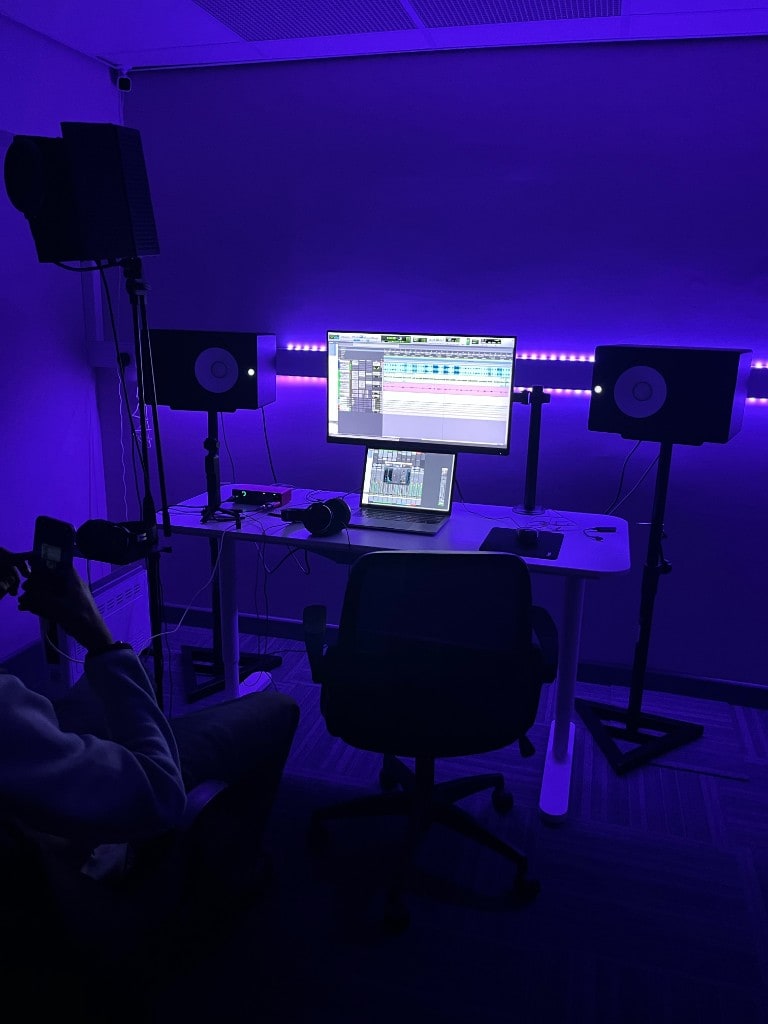 Symmetrical Warrington Music Studio control room with Yamaha HS monitors, DAW on screen, and blue LED lighting.