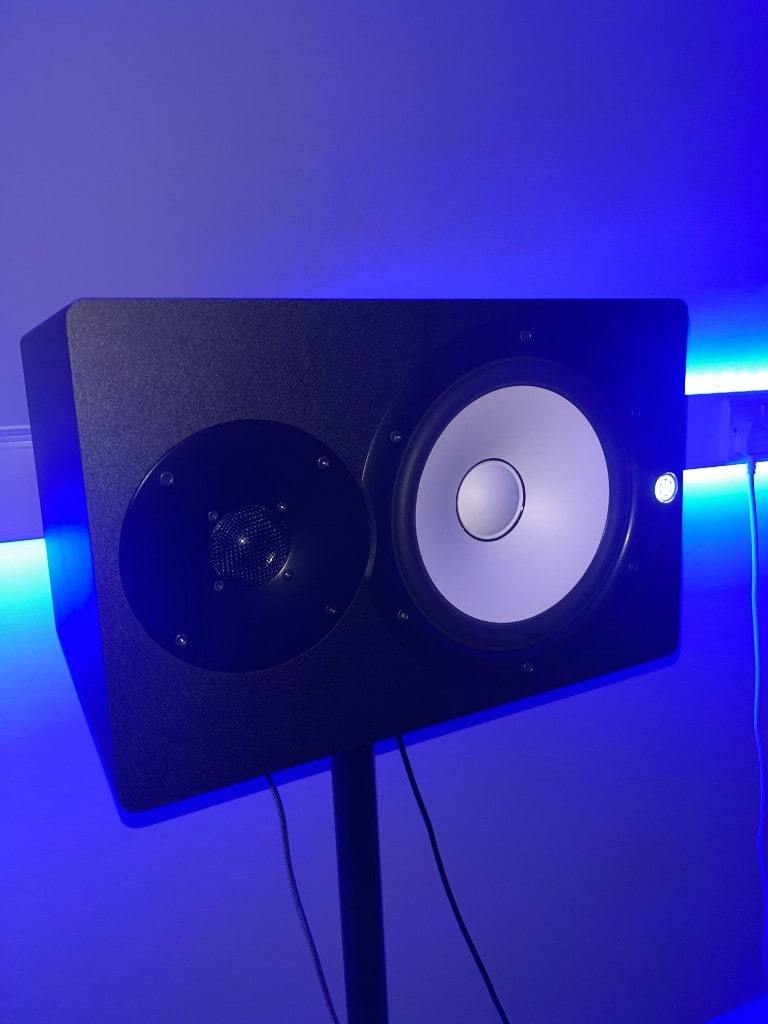 Yamaha HS studio monitor mounted horizontally on a stand with blue LED backlight at Warrington Music Studio.